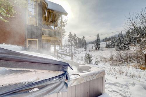 a house with snow on the roof of it at Need for Speed in Donnelly