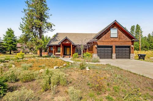 a log house with a driveway in front of it at Sunset Cabin in McCall