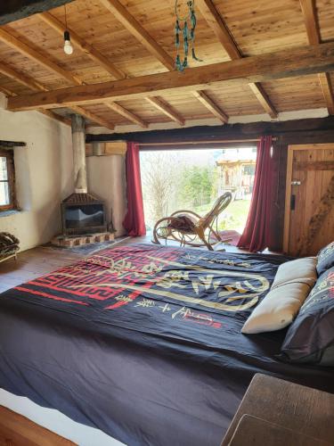 a large bed in a room with a window at Wild mountains in La Brigue