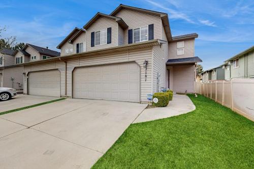 a house with two garage doors in a yard at Park View Townhouse in Boise