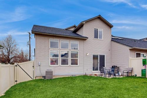 a house with a fence and chairs in the yard at Park View Townhouse in Boise