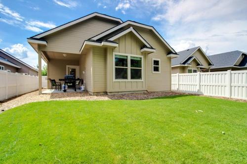 a house with a white fence and a yard at Sunglow Townhouse in Boise