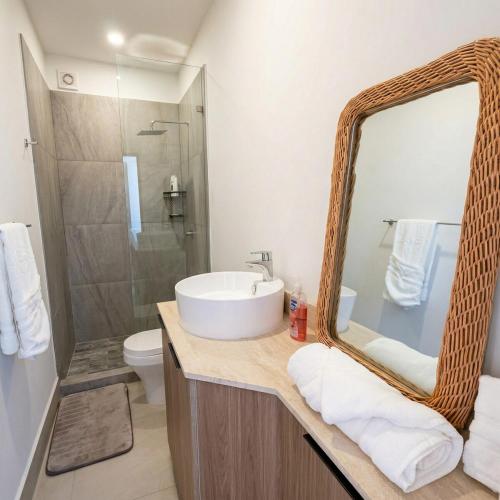 a bathroom with a sink and a mirror at Kocoy Oceanfront condo in Punta Peninsula in Bahía Kino
