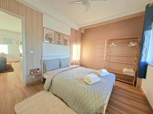 a bedroom with a bed with towels on it at Arrifana Sea Stay in Aljezur