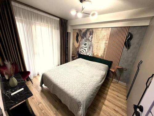 a bedroom with a bed with a zebra picture on the wall at Fly & Stay Otopeni Airport - Self Check-in in Otopeni