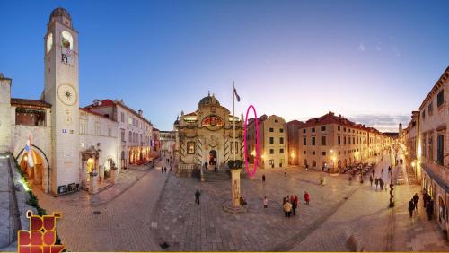 a group of people walking around a city street at Miró Studio Apartments Dubrovnik in Dubrovnik