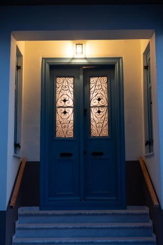 a blue door with stairs with a light above it at Eleofilos Old Town in Mytilene