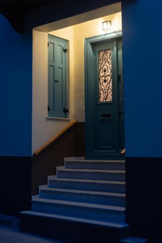 a blue door with stairs in front of a building at Eleofilos Old Town in Mytilene