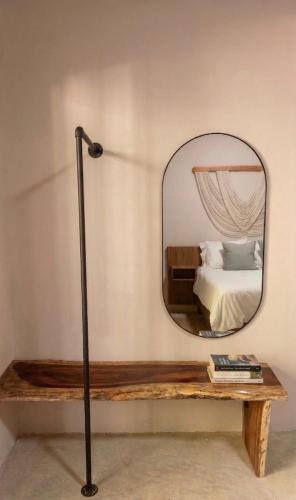 a mirror on a table in a bedroom with a bed at Casa Florentina in Tulum
