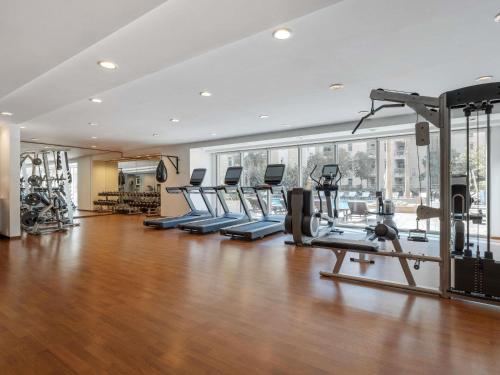 a gym with treadmills and ellipticals in a building at Swissôtel Living Al Ghurair Centre Dubai in Dubai