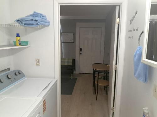 a kitchen with a door leading to a dining room at Cosy single-level home with laundry and parking in Huntington
