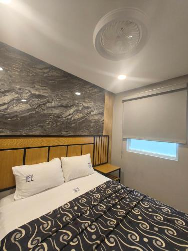 a bedroom with a large bed with a large painting on the wall at Hotel Torreon in Mexico City