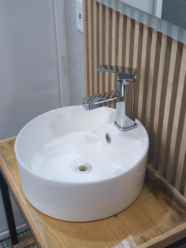 a white sink sitting on top of a wooden counter at Hotel Torreon in Mexico City