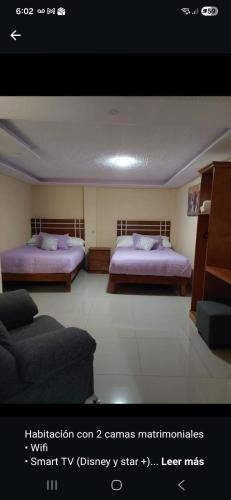 a living room with two beds and a couch at HOTEL PUEBLO BONITO in Zacatlán