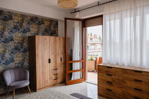 a bedroom with a wooden cabinet and a window at Appartamento Melo Grano in Tuoro sul Trasimeno