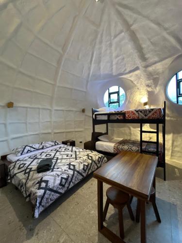 a bedroom with two beds and a table in a room at Animal Glamping in Pomona