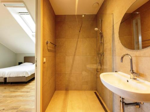 a bathroom with a sink and a shower at Villa with Heated Pool, Sauna in Aalten