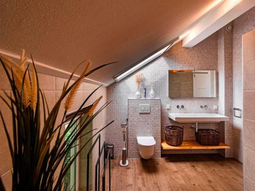 a bathroom with a sink and a mirror at Water Villa, Sauna & Beach in Sibculo