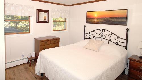 a bedroom with a white bed and a window at Summer Breeze in Cape May Point