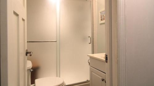 a white bathroom with a toilet and a shower at Summer Breeze in Cape May Point