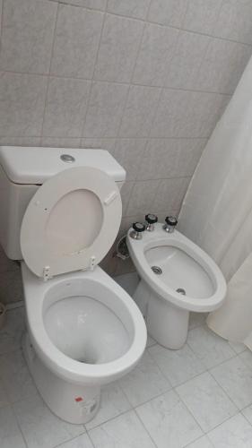 a bathroom with a toilet and a bidet at Refugio del Limonero - Colonial y Cercano in Córdoba