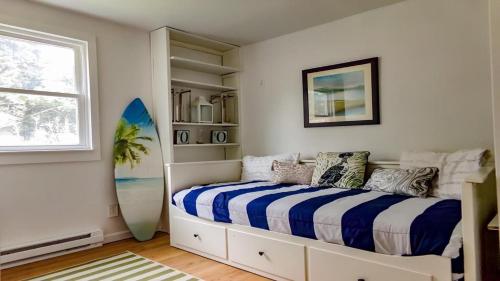a bedroom with a bed and a surfboard in it at 505 Sandalwood Road in Wildwood Highlands Beach