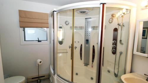 a bathroom with a shower with a toilet and a sink at 505 Sandalwood Road in Wildwood Highlands Beach