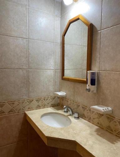 a bathroom with a sink and a mirror at Posada Merlo in Merlo