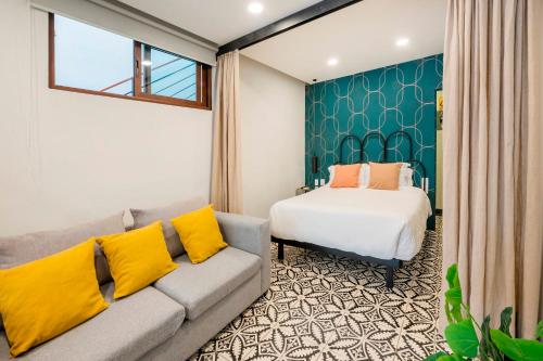 a living room with a couch and a bed at INDEPENDENCIA 2 · Small and Modern Apt for four in Oaxaca City