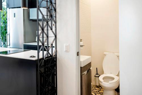 a bathroom with a toilet and a sink at INDEPENDENCIA 2 · Small and Modern Apt for four in Oaxaca City