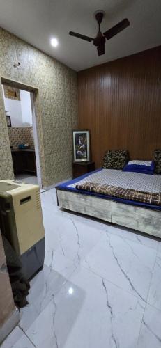 a bedroom with a bed and a marble floor at Home stays in Jammu