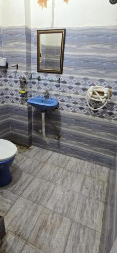 a bathroom with a blue sink and a mirror at Home stays in Jammu