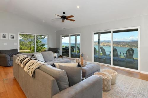 a living room with a couch and a ceiling fan at Vineyard Setting With 180 Panoramic Lake Views in Lower Lake