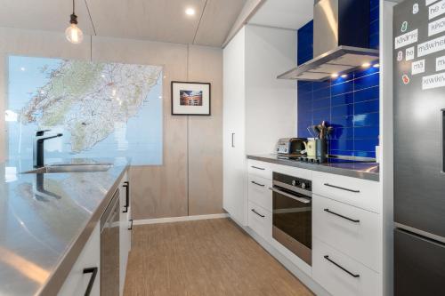 a kitchen with a sink and a map on the wall at The Red Door in Martinborough