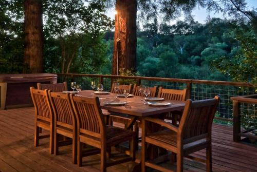 a wooden table and chairs on a deck at Heron House - Hot Tub And Wine Tastings Included in Healdsburg