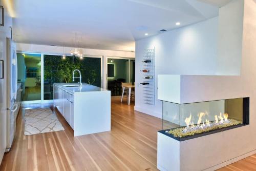 a kitchen with a fireplace in the middle of a room at Fitch St Escape - Wine Tastings Included in Healdsburg