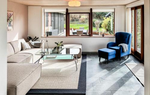 a living room with a couch and a table at 3 Bedroom Beautiful Home In Asperup in Asperup