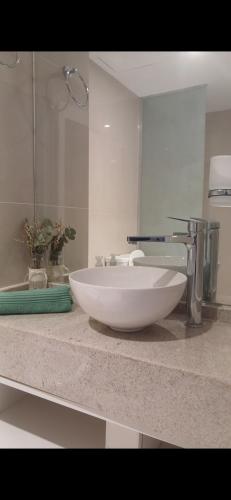 a bathroom with a white sink and a mirror at Centro suite II in Santiago del Estero
