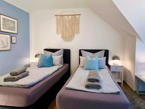 two beds in a room with blue and white at INTERGO Apartments in Brackel