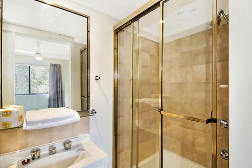 a bathroom with a shower and a sink at Allamanda 37 in Long Jetty