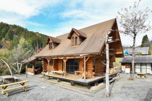 a log cabin with a porch and a house at Logland Okumino - Camp - Vacation STAY 42150v in Gujo