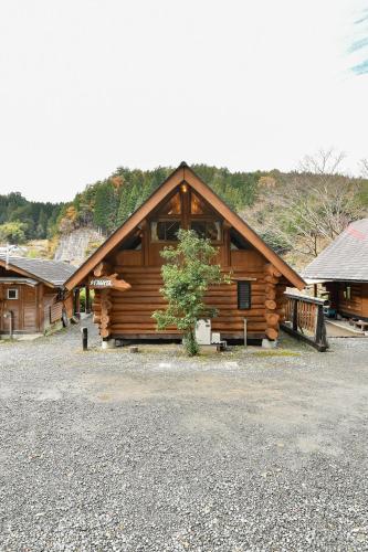 a log cabin with a tree in front of it at Logland Okumino - Camp - Vacation STAY 42151v in Gujo