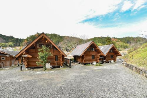a row of wooden cabins on a mountain at Logland Okumino - Camp - Vacation STAY 42152v in Gujo