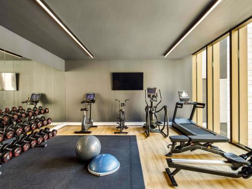 a gym with several exercise equipment in a room at The Municipal Hotel Liverpool - MGallery Collection in Liverpool