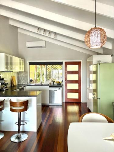an open kitchen with a counter and a refrigerator at The Sage Sea Shack in Caloundra