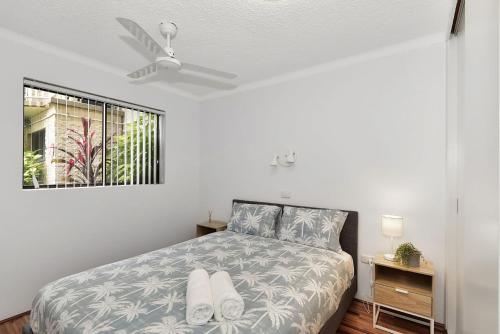 a bedroom with a bed and a ceiling fan at Allamanda Unit 22 in Long Jetty