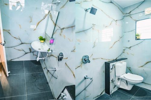 a bathroom with a toilet and a sink at Keerthis Elite Hotel near Kempegowda international airport in Bangalore