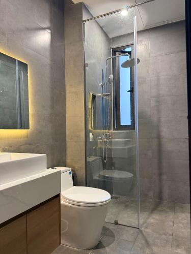 a bathroom with a toilet and a glass shower at Airport Homestay 2 in Danang