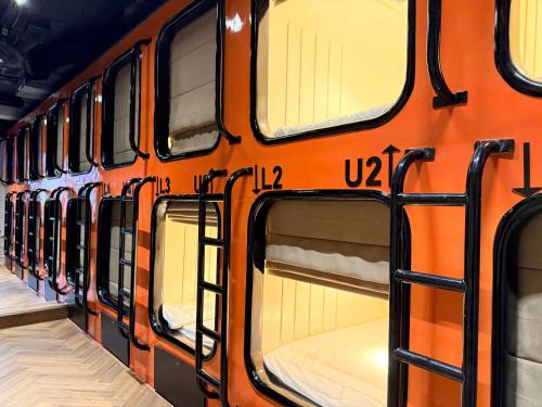 an orange bus with windows on the side of it at Factor Inn - Old Quarter Centre in Hanoi