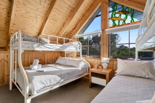 two bunk beds in a room with a window at The Great Escape in Marengo